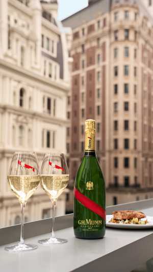 G.H.Mumm | Two glasses of champagne and a bottle of G.H.Mumm sit on a windowsill