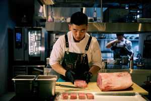 aKin Toronto | Chef Eric Chong prepares a dish at aKin