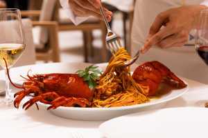 Milos Toronto | The Astakomakaronada is a striking lobster pasta in a tomato sauce