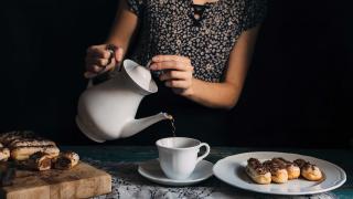 How to drink tea: a woman pouring tea with éclairs