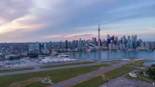 Billy Bishop Toronto City Airport in front of the Toronto skyline at dusk