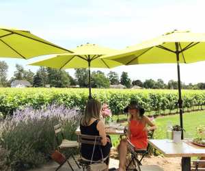 Niagara Wineries | Two women eat lunch on outdoor patio at The Good Earth Food and Wine Co.