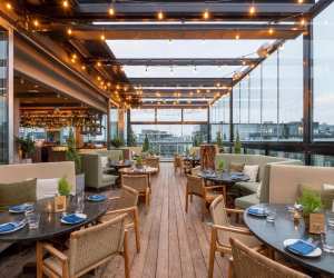 Cozy booths and tables at Harriet's Rooftop in Toronto