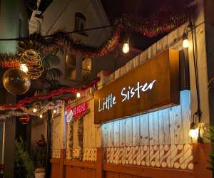 A sign for Little Sister bar and Java Jingle in downtown Toronto