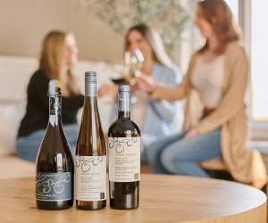 Thirty Bench wines on a table in front of a group of women