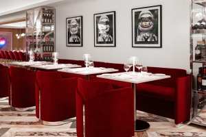 Restaurants with art | Plush red velvet seating at Sofia
