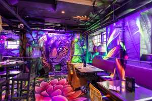 Restaurants with art | A wall mural depicts a jungle cat inside Selva