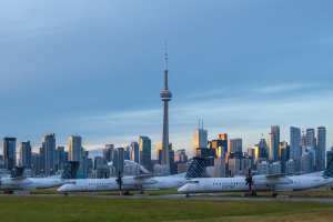 Airplanes at Billy Bishop Toronto City Airport in front of the Toronto skyline
