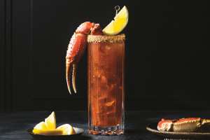 The history of the caesar cocktail |  A caesar topped with a lobster claw