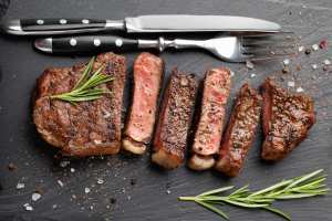Is salt bad for you? | Closeup of a ready to eat steak with herbs, salt, garlic and butter on a stone Board Is salt bad for you? | Closeup of a ready to eat steak with herbs, salt, garlic and butter on a stone Board