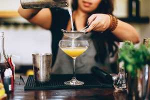 A bartender pouring a drink at Foodism 40 A bartender pouring a drink at Foodism 40