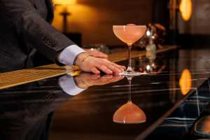 Best cocktail bars in Toronto | A bartender presenting a drink at Clockwork
