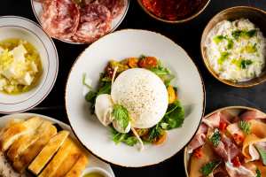 New Toronto restaurants | Burrata surrounded by other dishes at Bar Notte