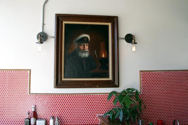 Best fish and chips in Toronto | A painting of an old captain at Sea Witch Fish and Chips