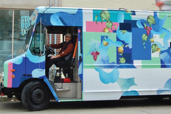 Toronto food trucks | A man driving the colourful La Palma food truck