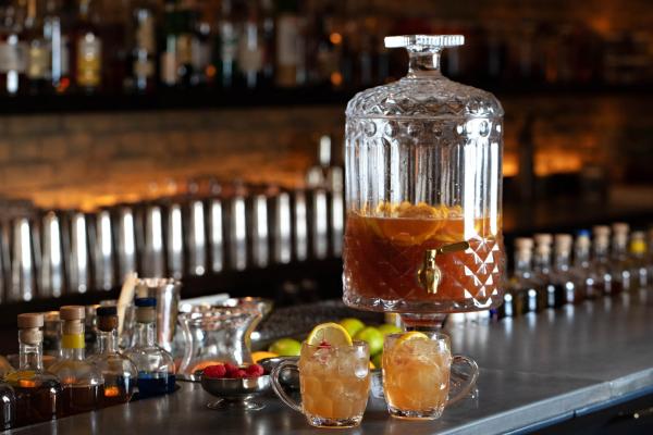 Punch recipes and big batch cocktails | Robin Goodfellow's The Ridge Hill Punch served in a drink dispenser with two glasses