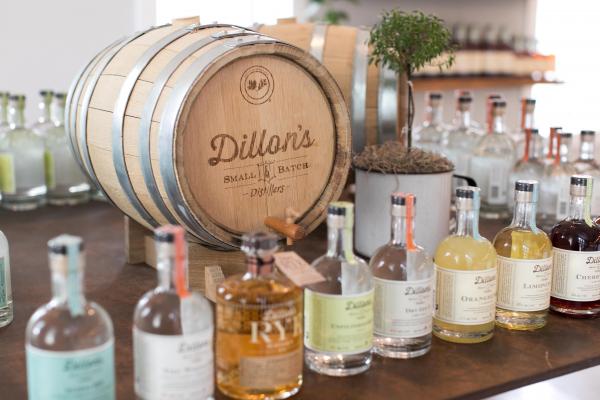 Ontario distilleries and alcohol stores | Dillon's lineup of spirits in front of a barrel