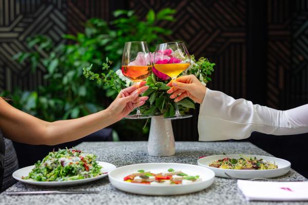 People cheers wine glasses on the patio at Sofia Restaurant in Yorkville, Toronto