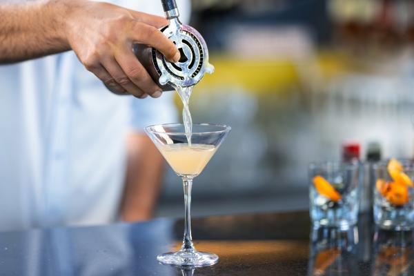 Pouring a martini into a glass