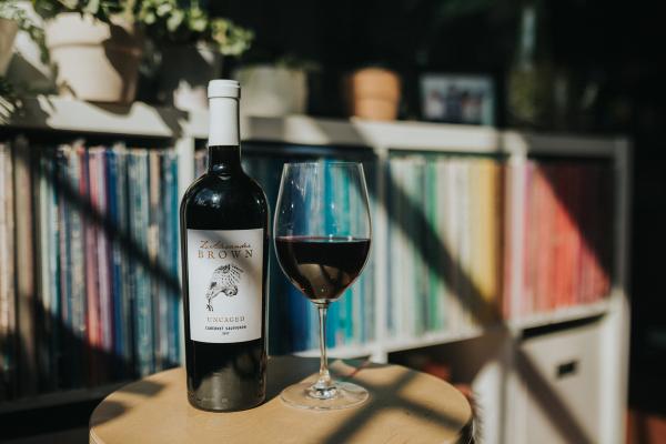 Z. Alexander Brown Uncaged Cabernet Sauvignon against a bookshelf
