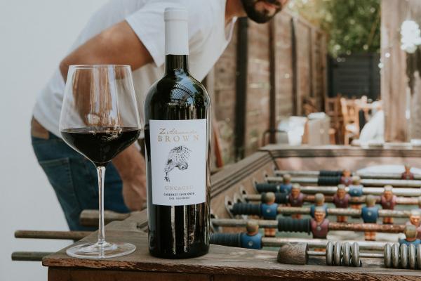 A bottle of Z. Alexander Brown Uncaged Cabernet Sauvignon on a foosball table