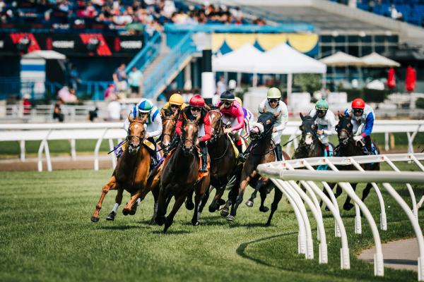 Jockeys race their horses at Woodbine Racetrack in Etobicoke