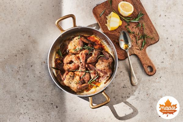 A pot of quail and a cutting board with lemons