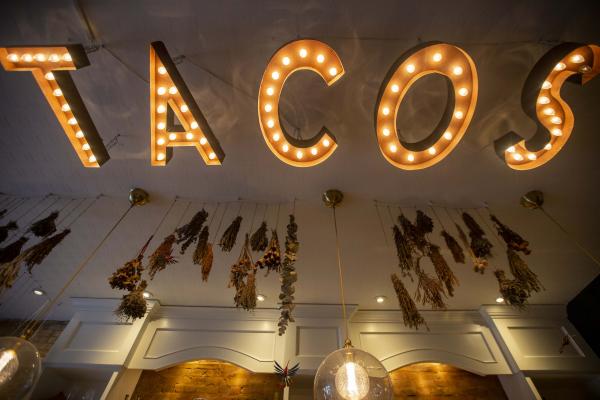 The neon TACOS sign inside La Bartola in Toronto The neon TACOS sign inside La Bartola in Toronto