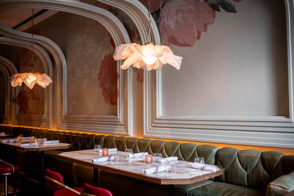 La Plume Toronto | Banquettes under floral chandeliers and a curving ceiling at La Plume in The Well La Plume Toronto | Banquettes under floral chandeliers and a curving ceiling at La Plume in The Well