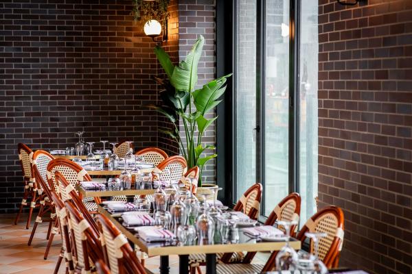La Plume Toronto | Set tables with bistro chairs at La Plume in The Well La Plume Toronto | Set tables with bistro chairs at La Plume in The Well