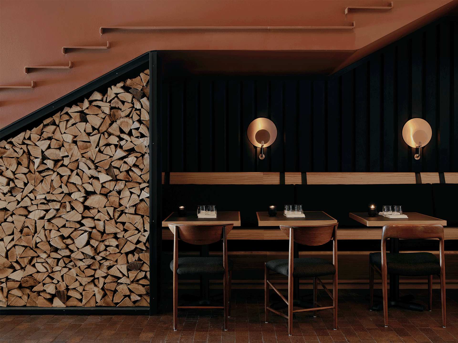 Best new restaurants Toronto | A set table besides chopped wood for the oven at Alder