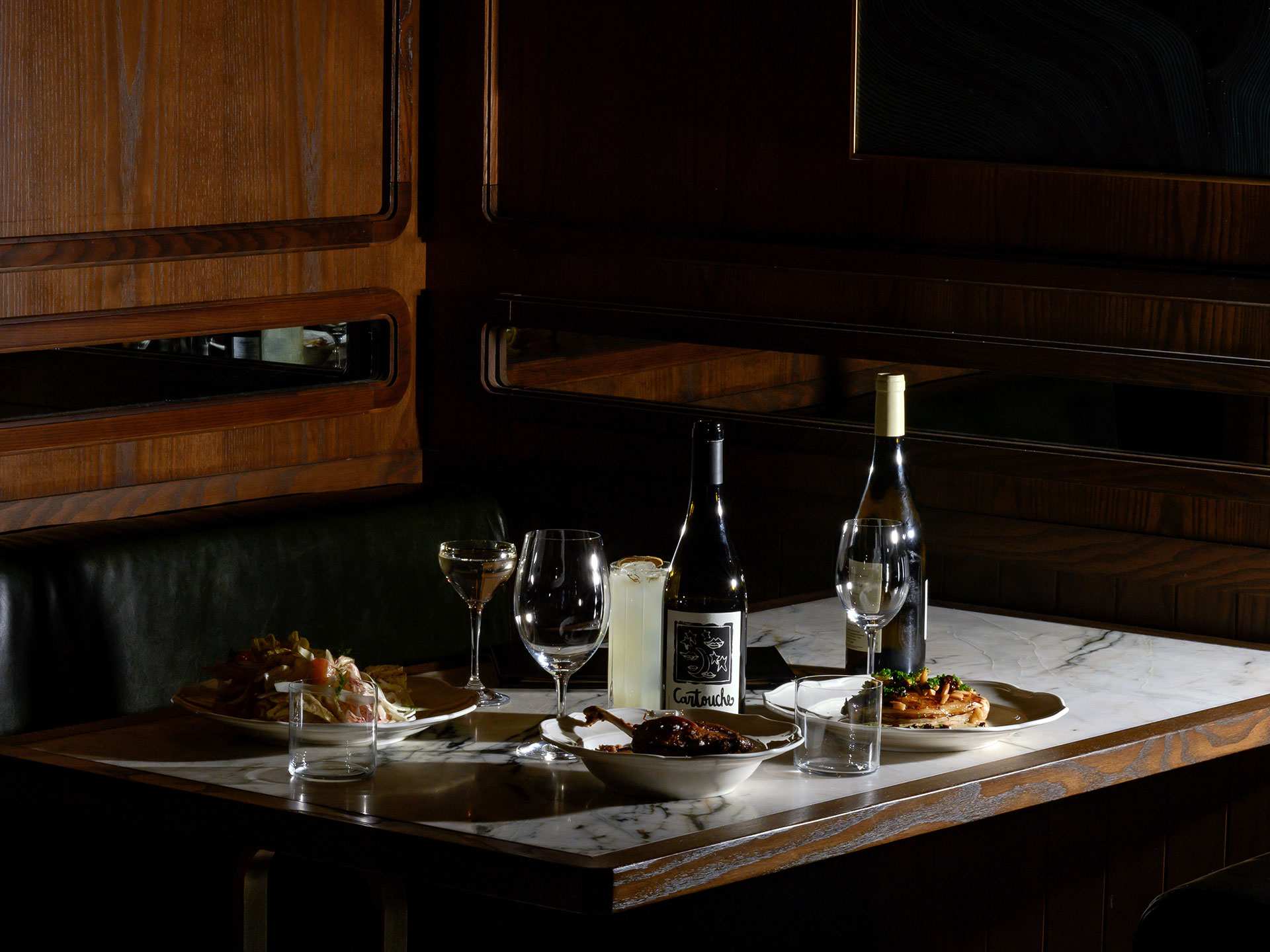 Romantic restaurants in Toronto | A spread of dishes and wine on a table at Parquet