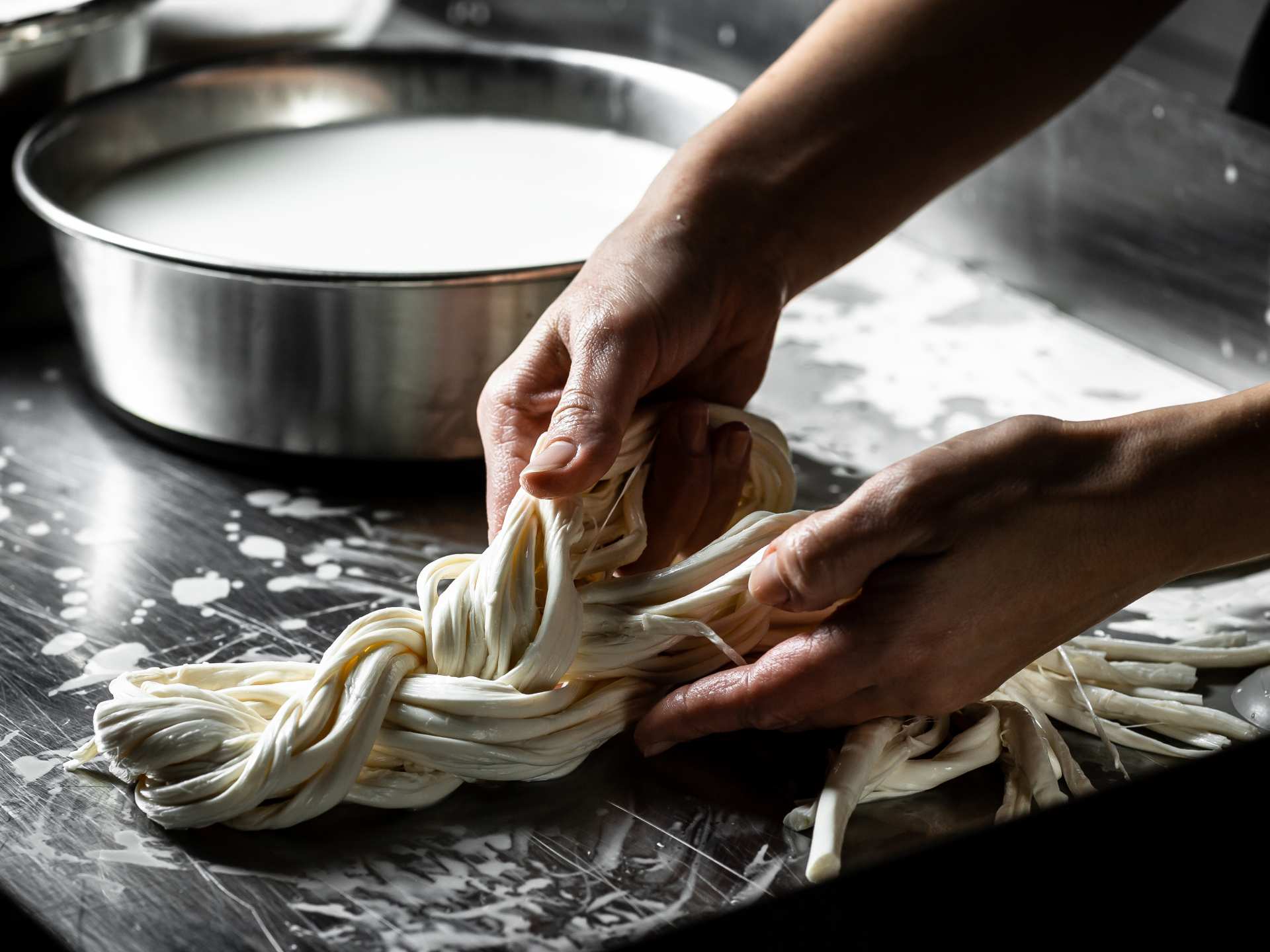 Stretching a pasta filata cheese by hand