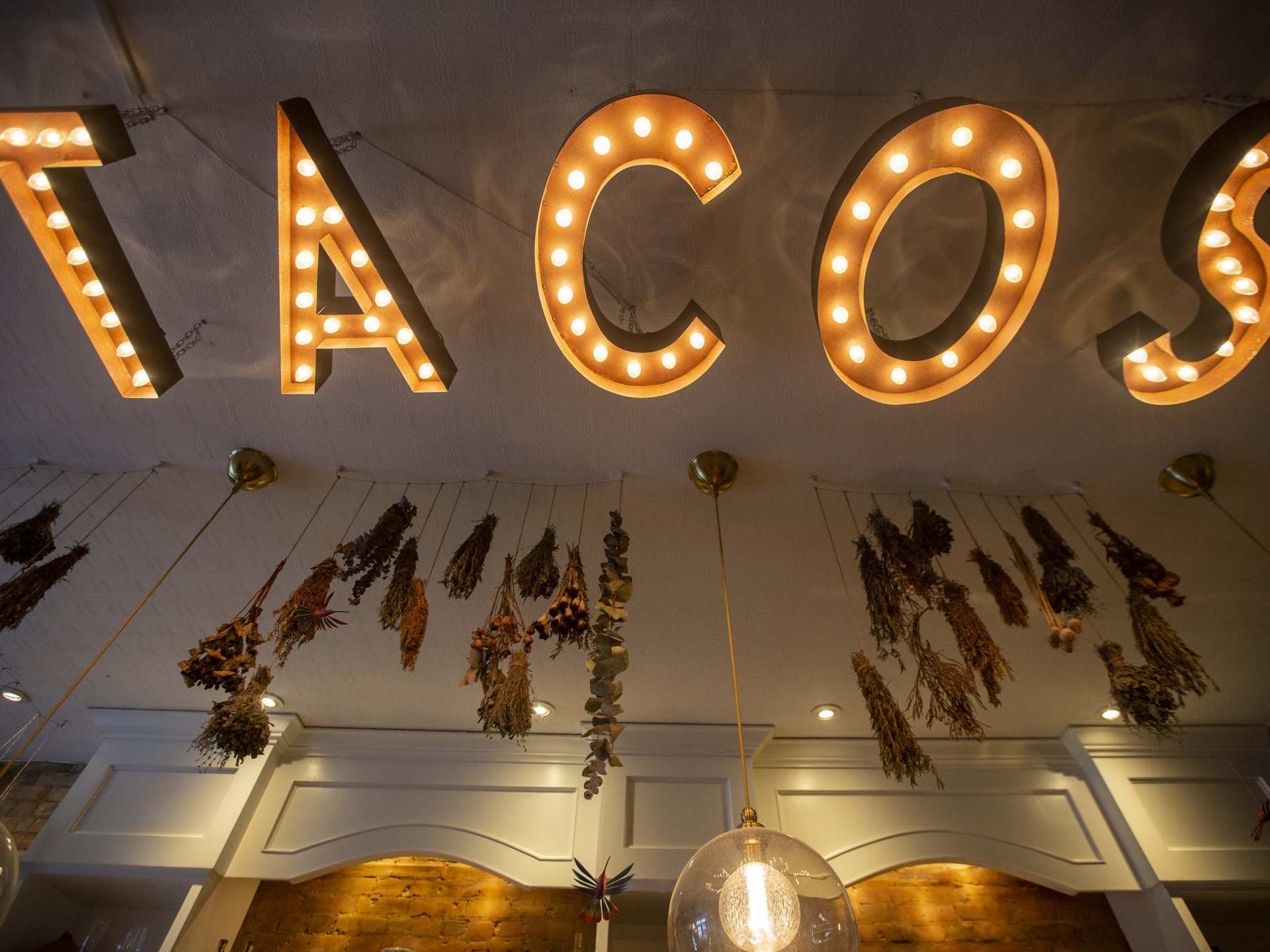Best Michelin Restaurants | The neon TACOS sign hanging from the ceiling at La Bartola