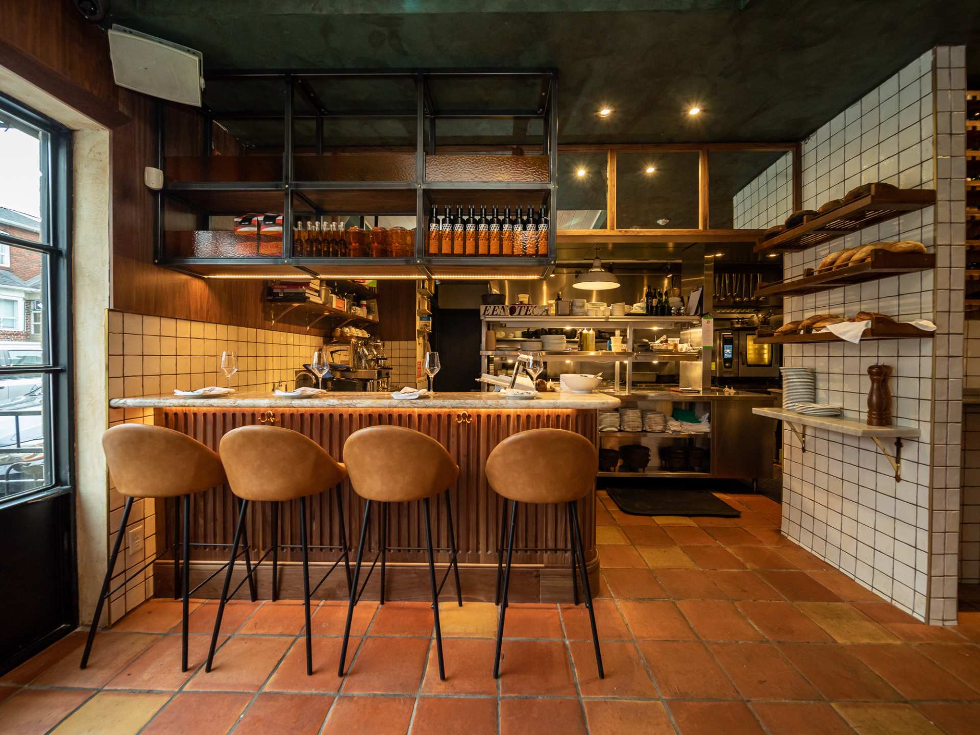 Best Michelin restaurants | The bar with stools and shelves at Enoteca Sociale