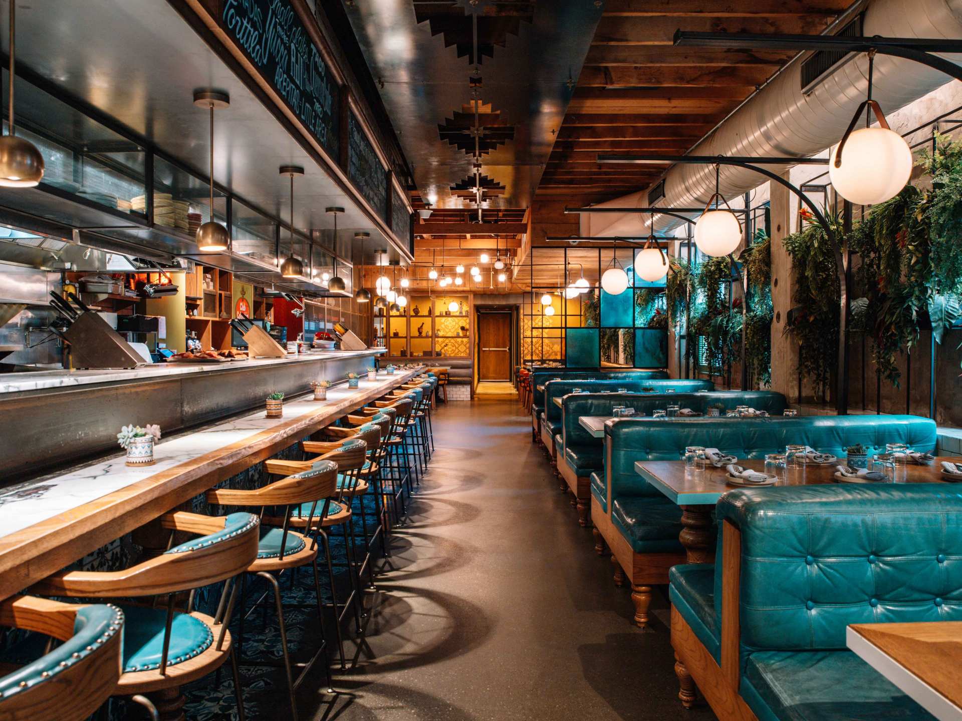 Late night food in Toronto | The dining room at Baro with blue booths and the bar