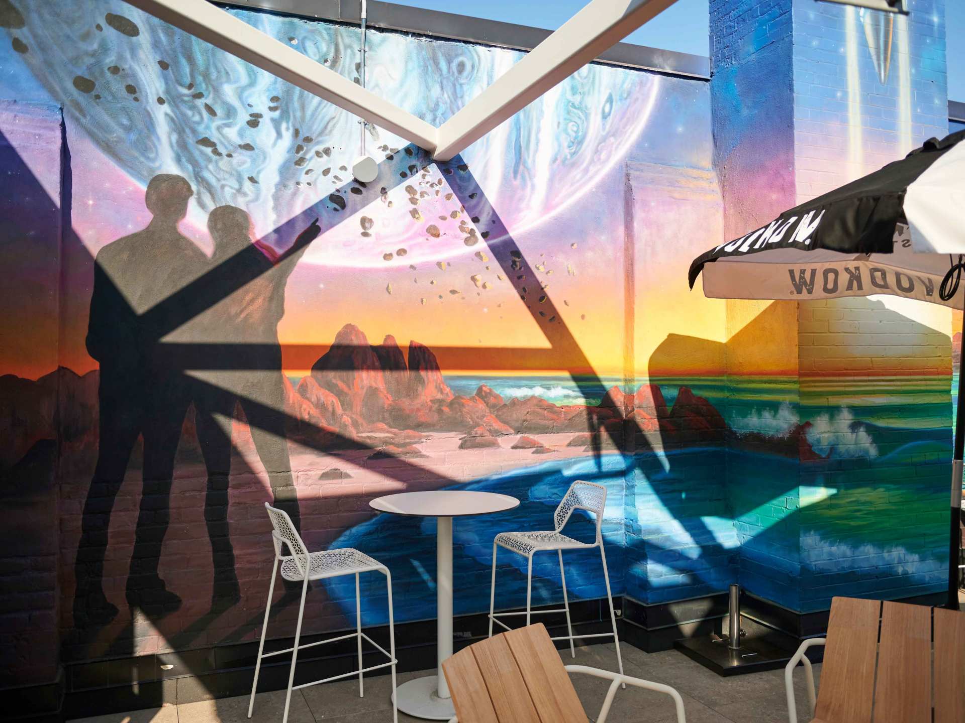 Best patios in Toronto | The colourful space mural on the patio at Offworld