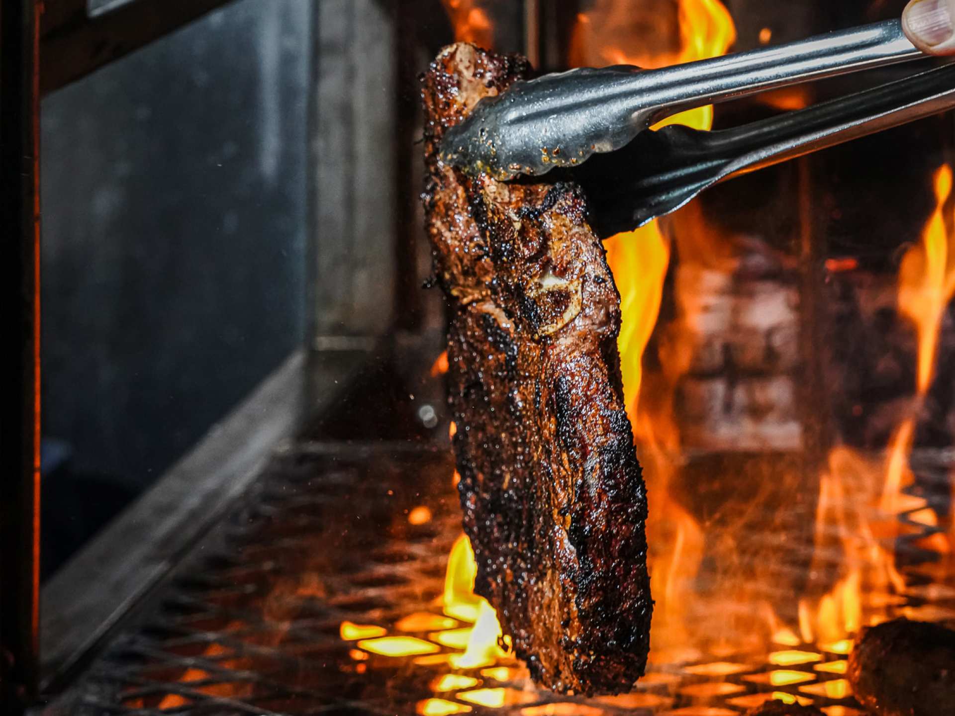 Best patios in Toronto | A steak on the charcoal barbecue at Baro