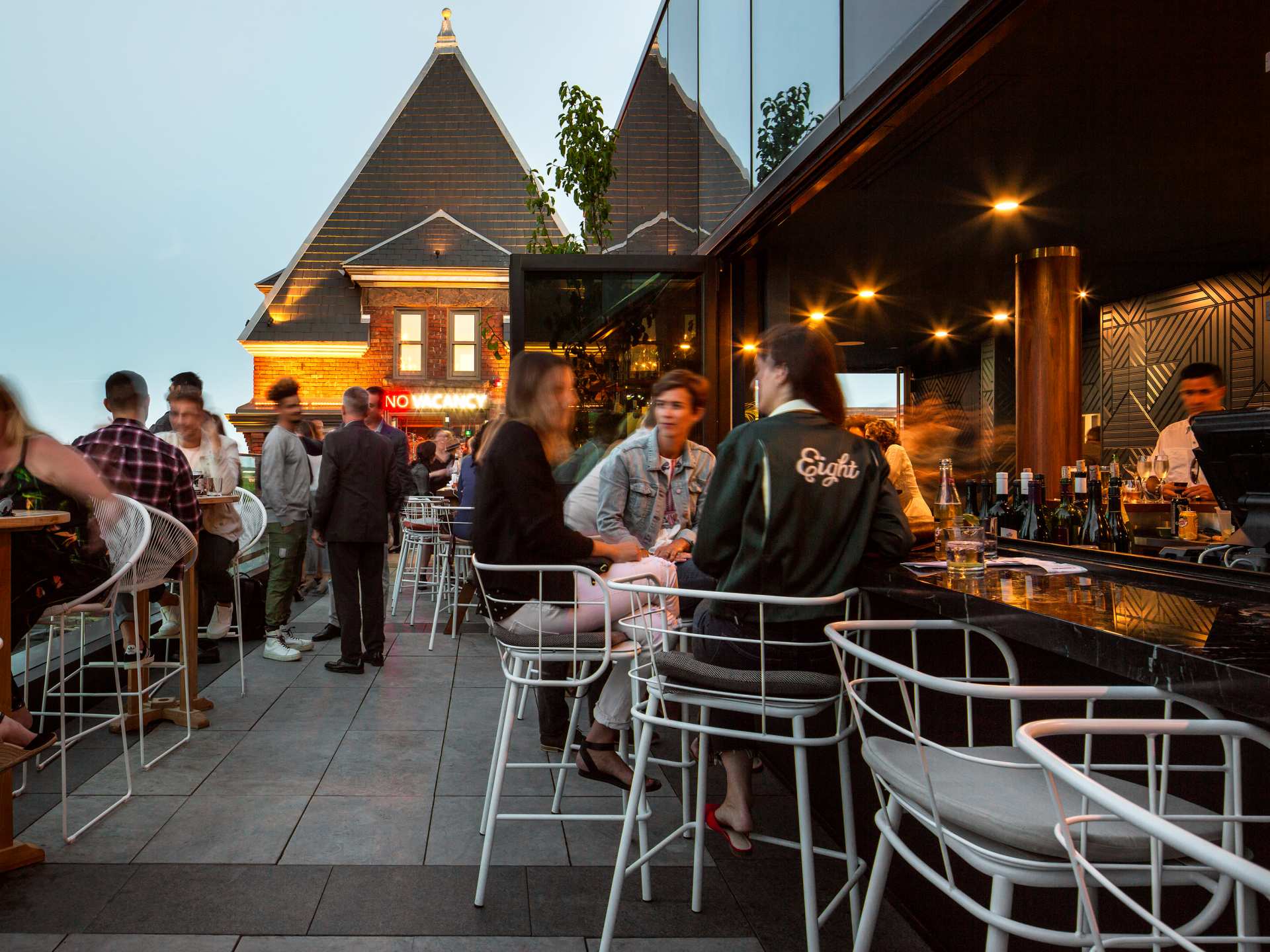 Best patios in Toronto | The crowded Rooftop at The Broadview Hotel at dusk
