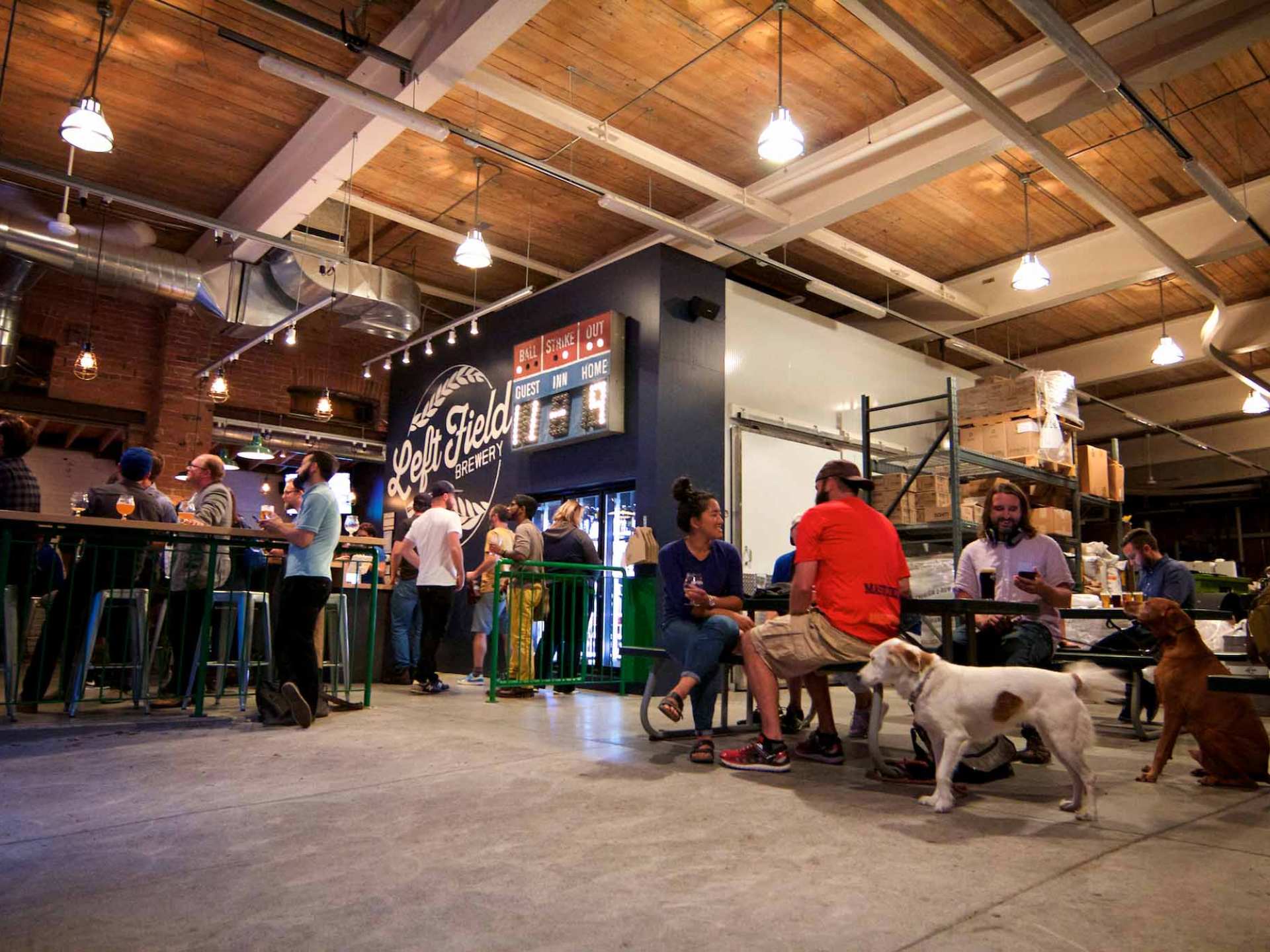 Best breweries in Toronto | Crowds of guests sitting at tables at Left Field Brewery
