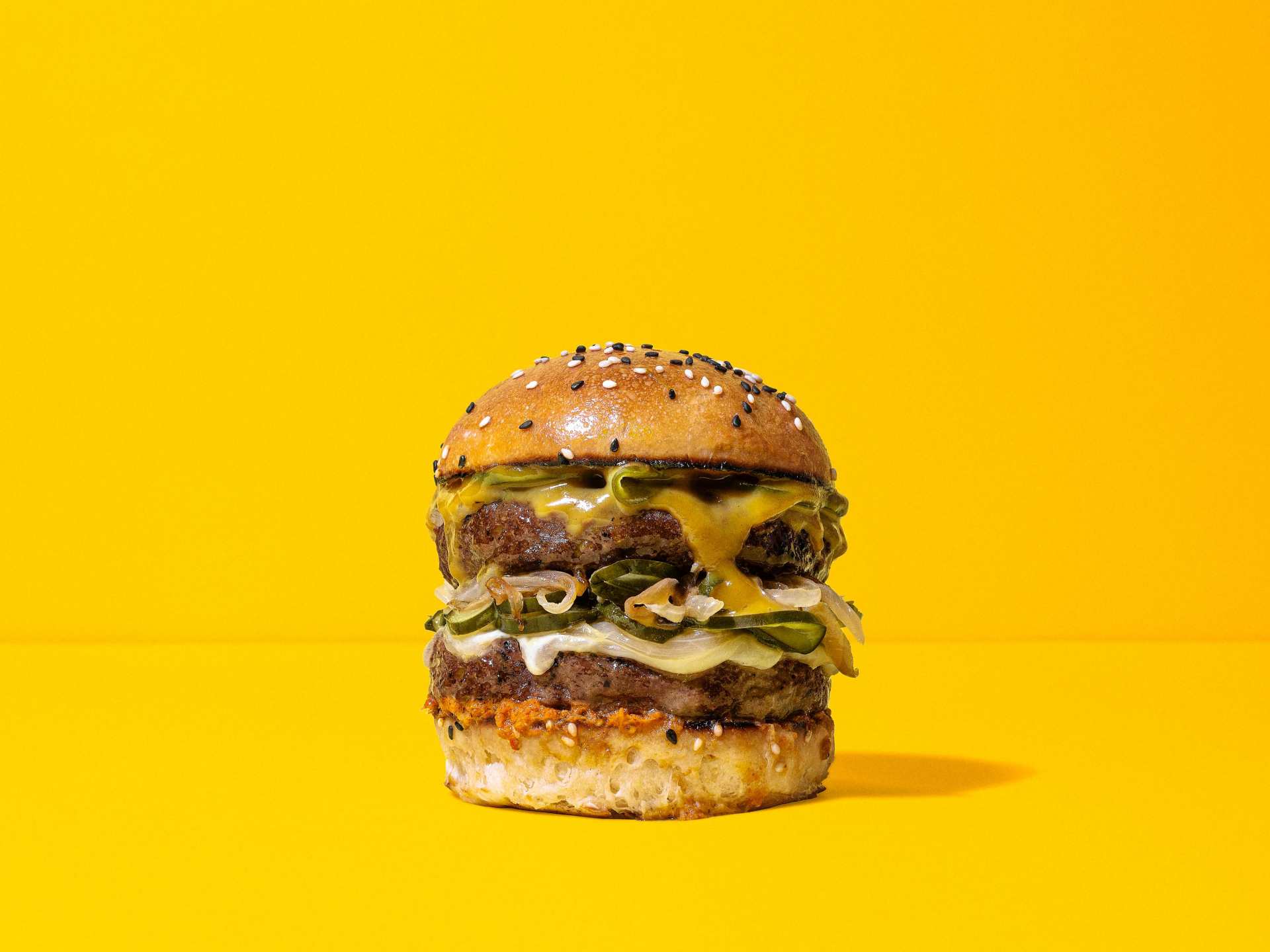 A NotCo double-decker burger on a yellow background
