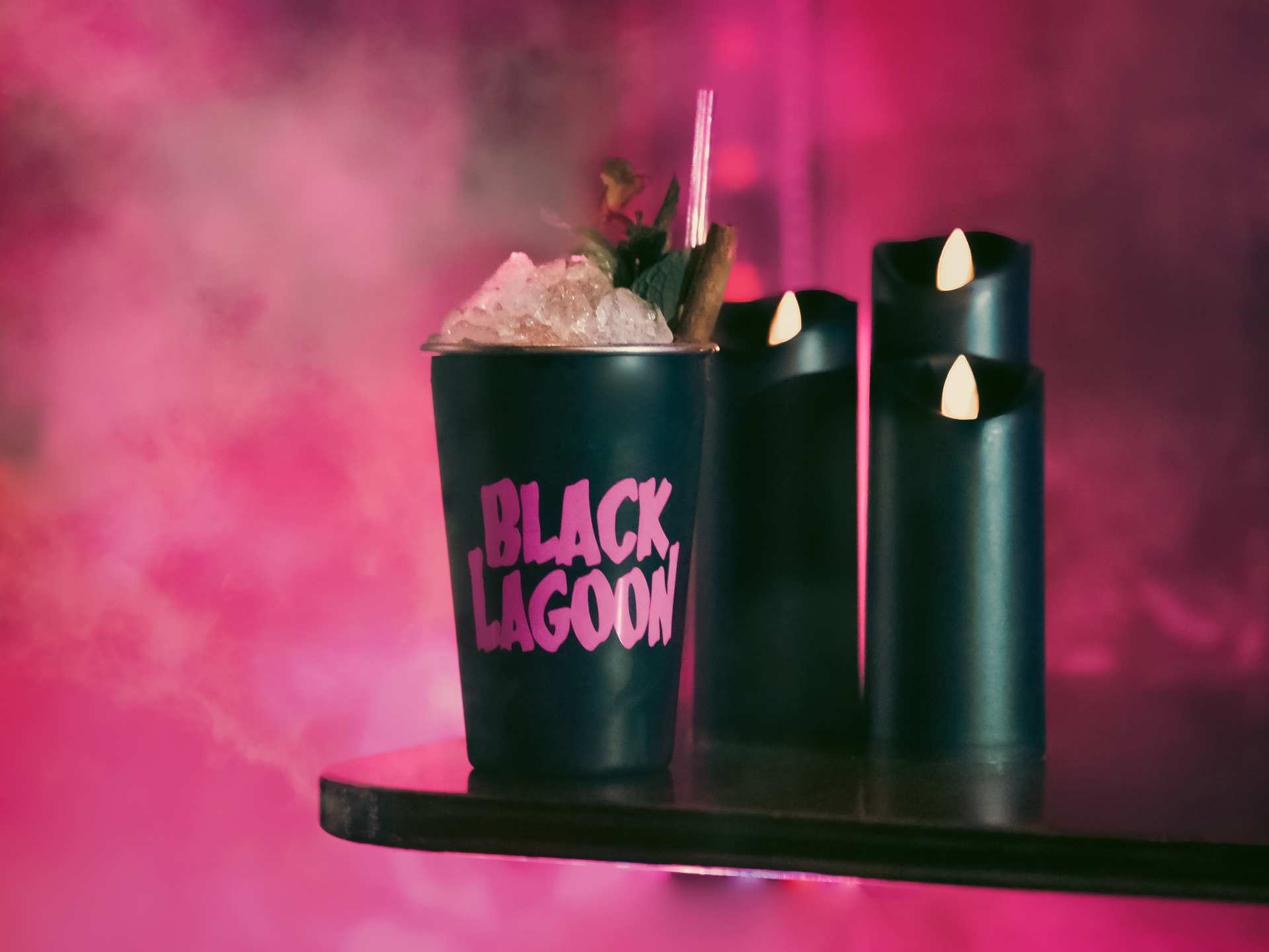 A spooky cocktail against a smoky pink background at the Black Lagoon Halloween pop-up at Bar Mordecai in Toronto