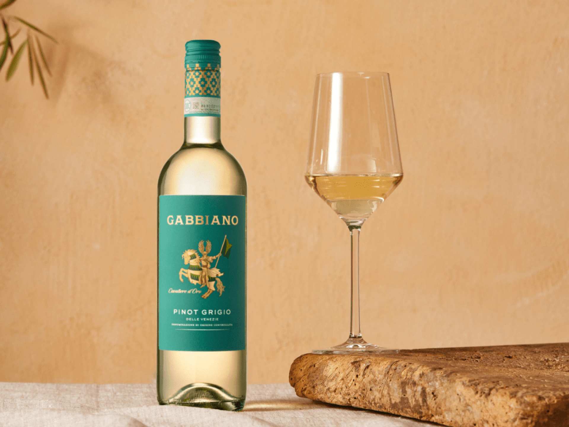 A bottle of Gabbiano Pinot Grigio IGT beside a glass of white wine
