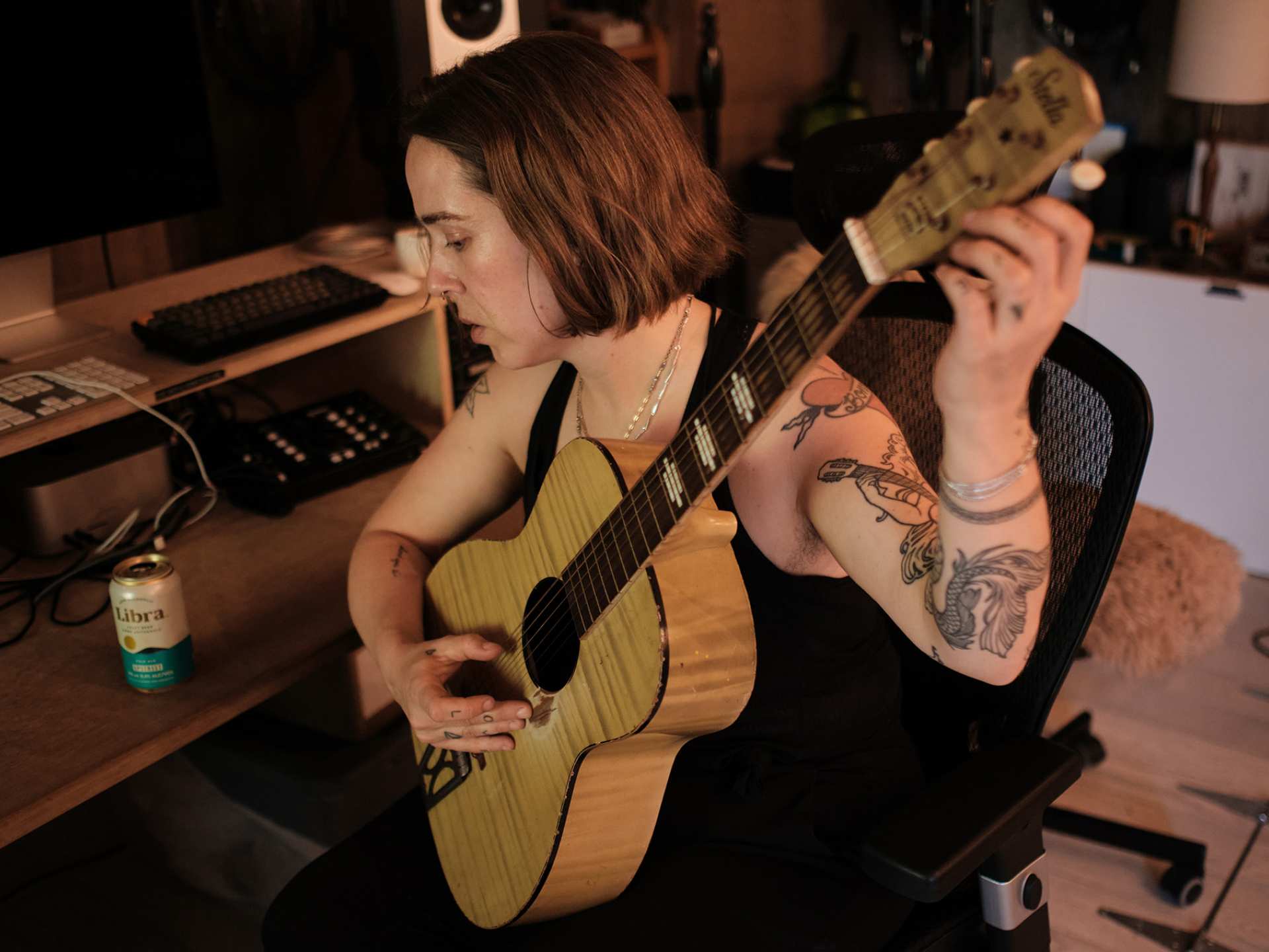 Serena Ryder tuning her guitar with a can of Libra