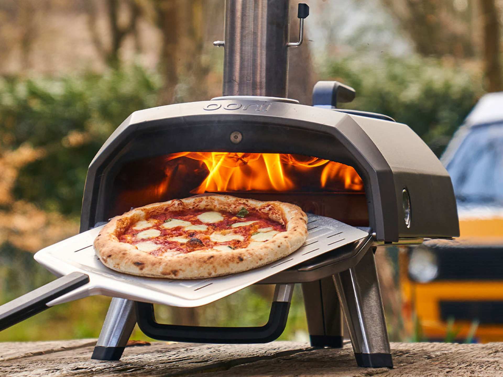 Taking a pizza out of the Ooni Karu 12G pizza oven