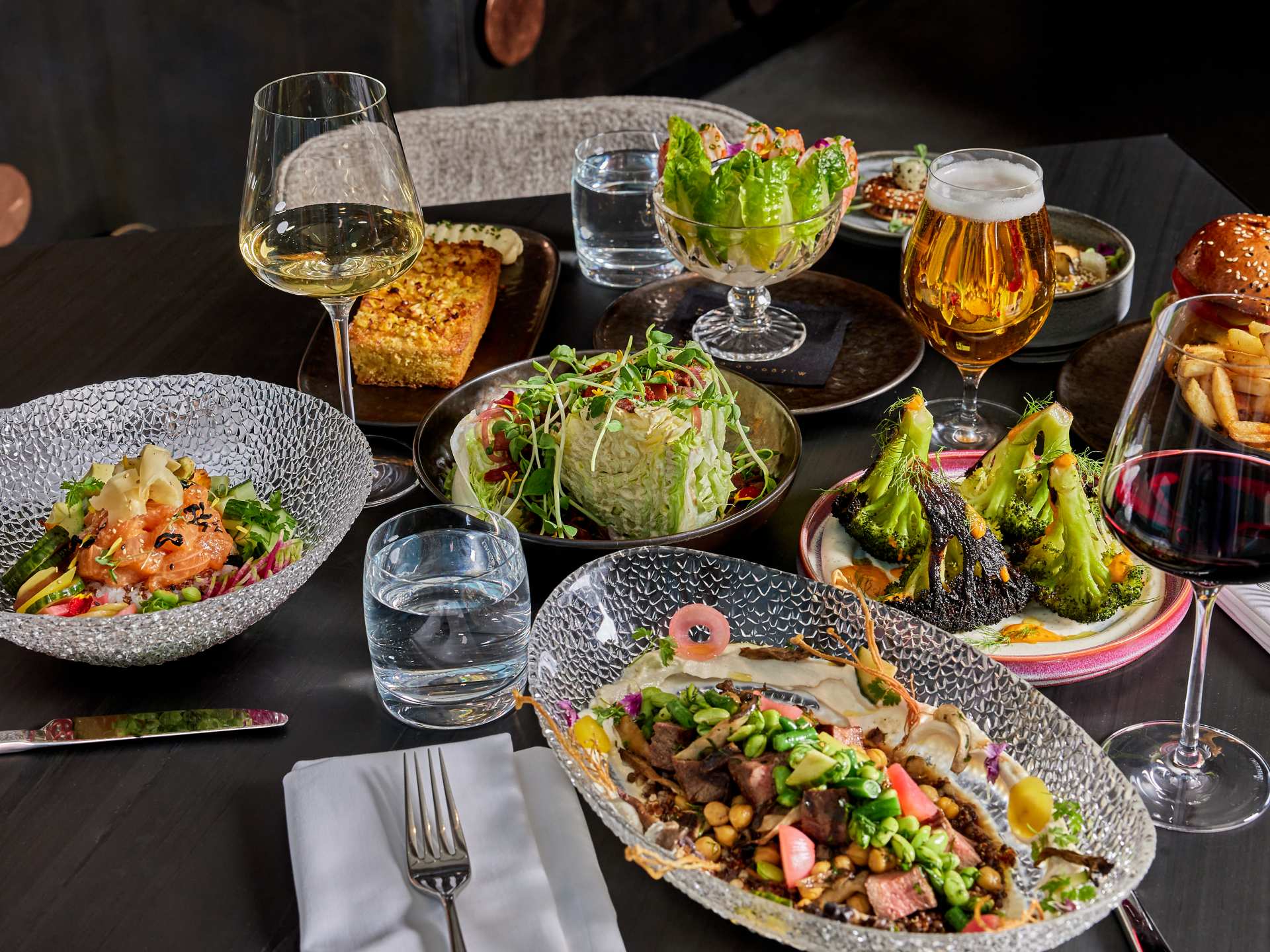 Aera restaurant | A spread of food including wedge salad, shrimp cocktail and burger
