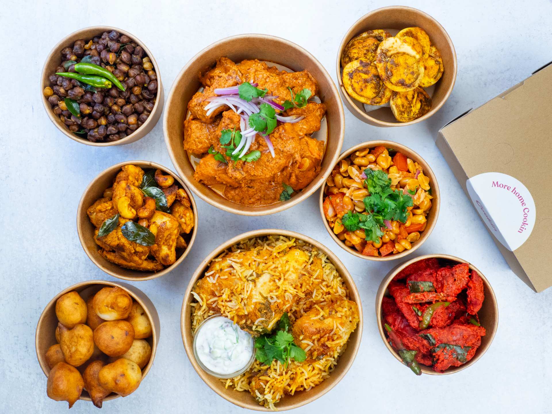 Cookin app for homemade food delivery | A spread of dishes in takeout containers from Tastes of Telanga
