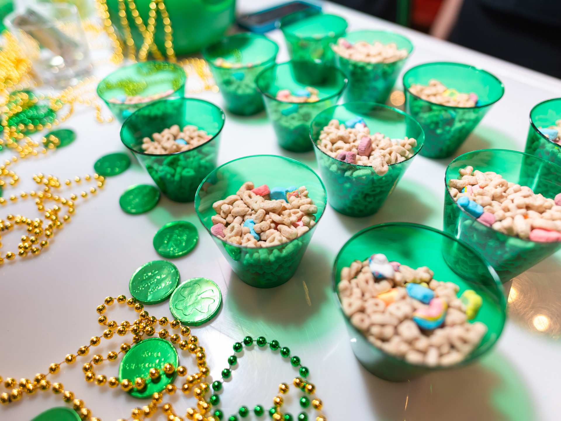 Cups of Lucky Charms and green coins at Guinness SPD Cups of Lucky Charms and green coins at Guinness SPD