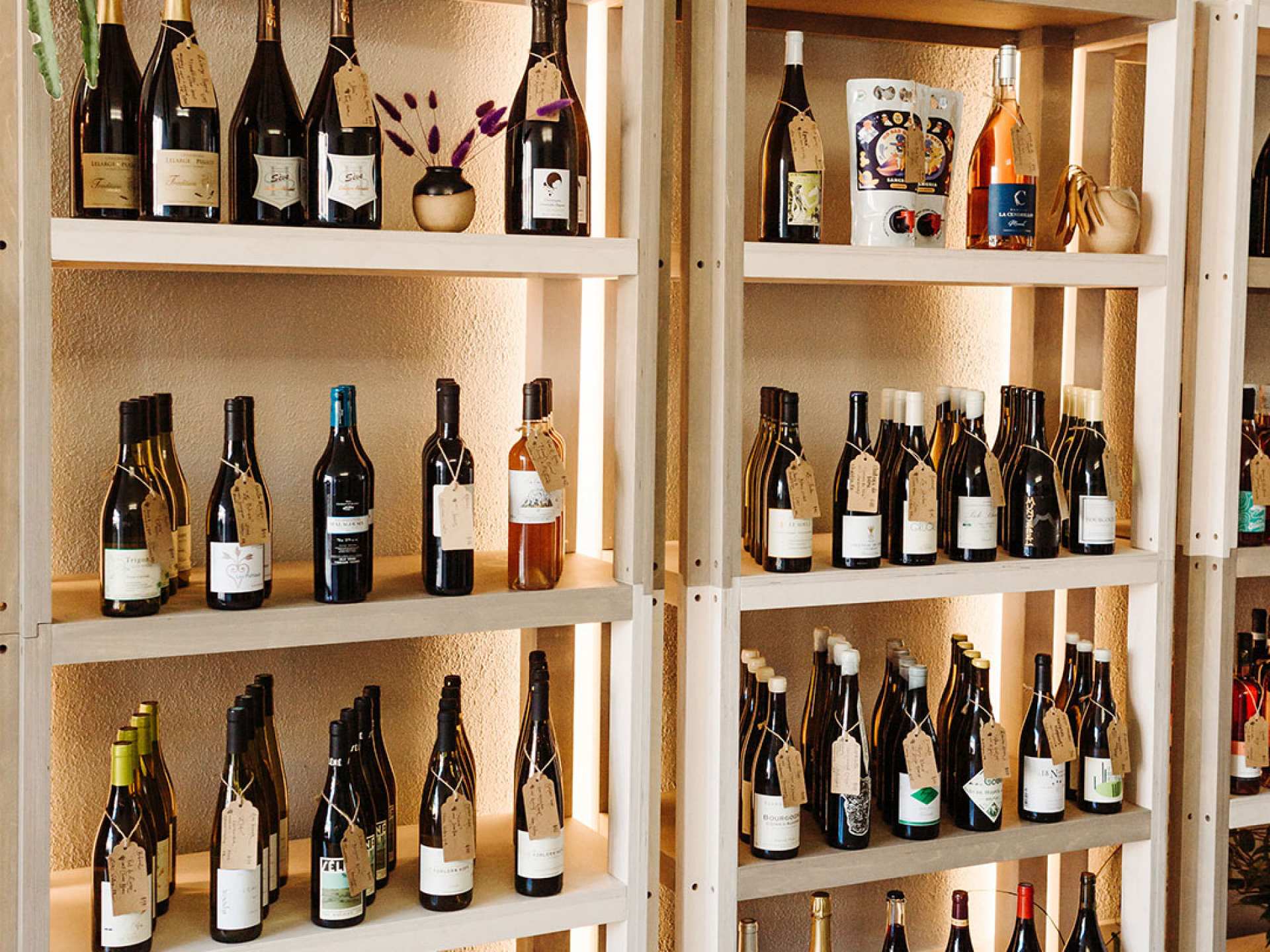 Best wine bars Toronto | A shelf of natural wine at Grape Witches on Dundas West
