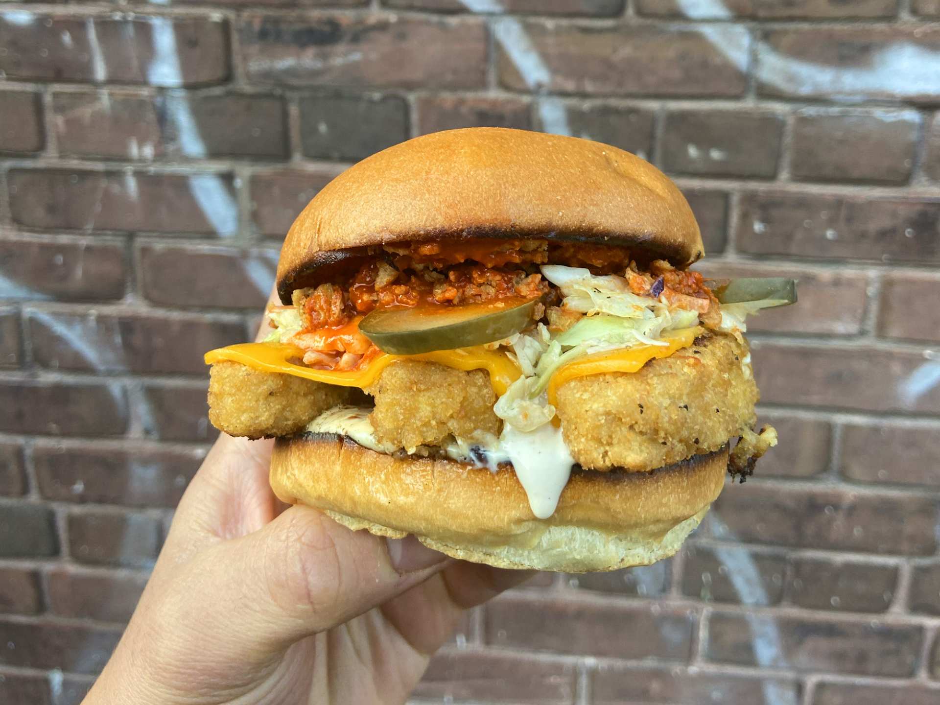 Best vegan restaurants in Toronto | A sandwich at Guerilla Burger with pickles and vegan breaded fillets